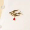 Zwaluw Broche In Goud En Rood-Urban Hippies Online